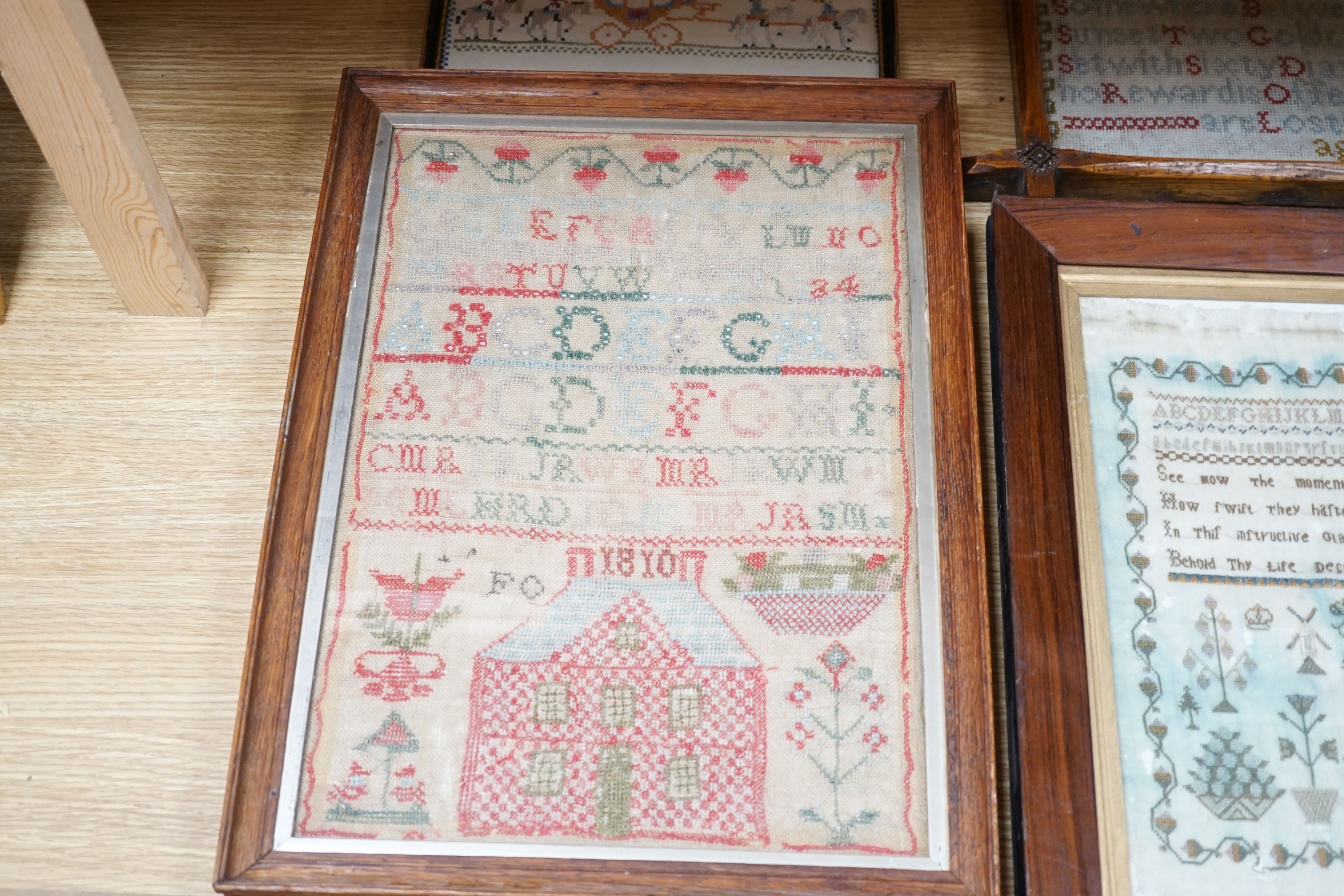 Four 19th century samplers, in glazed wood frames, largest 42cm high